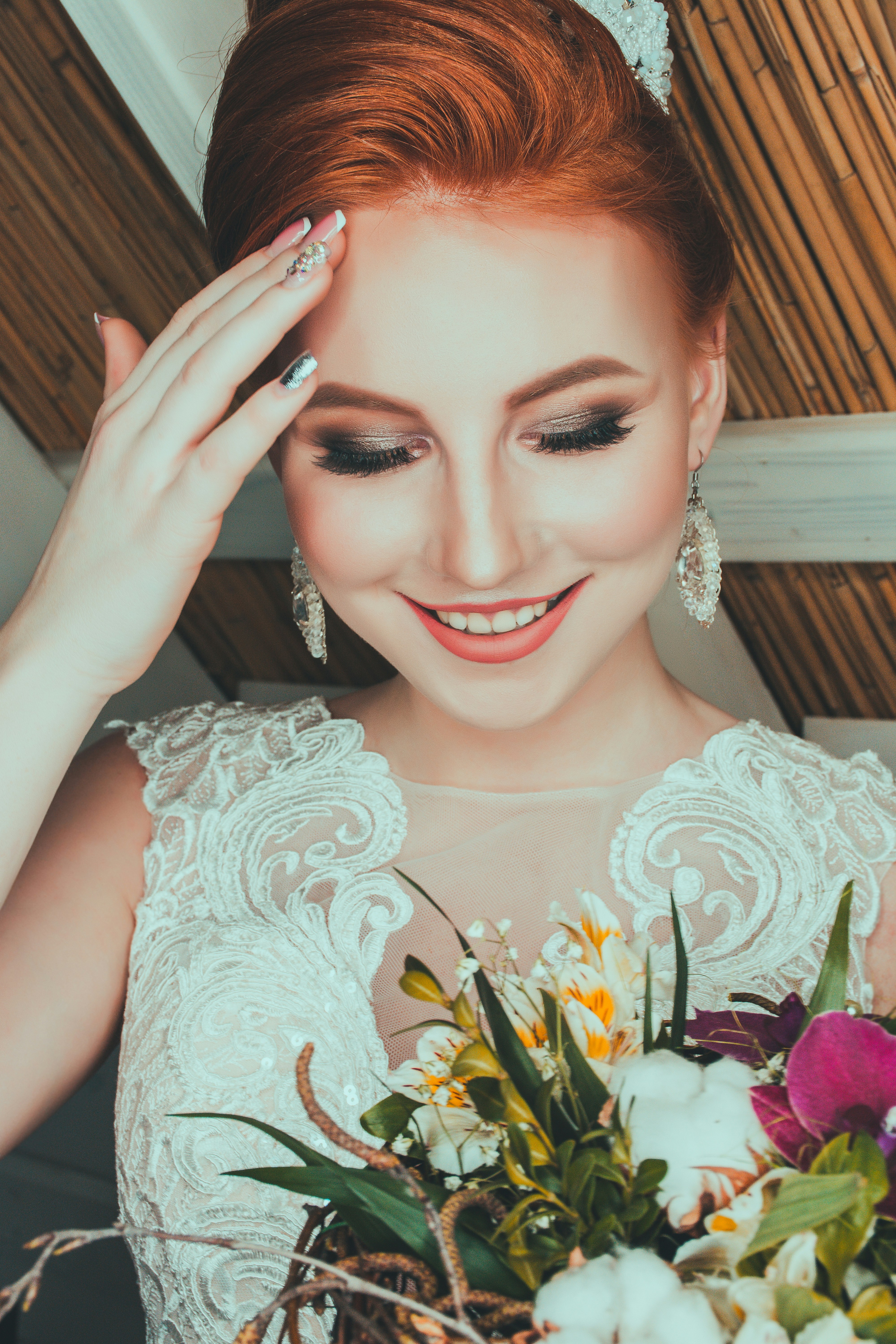 Redhead bride smiling with flowers