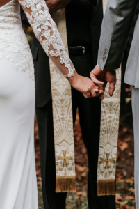 Wedding ceremony with bride and groom holding hands